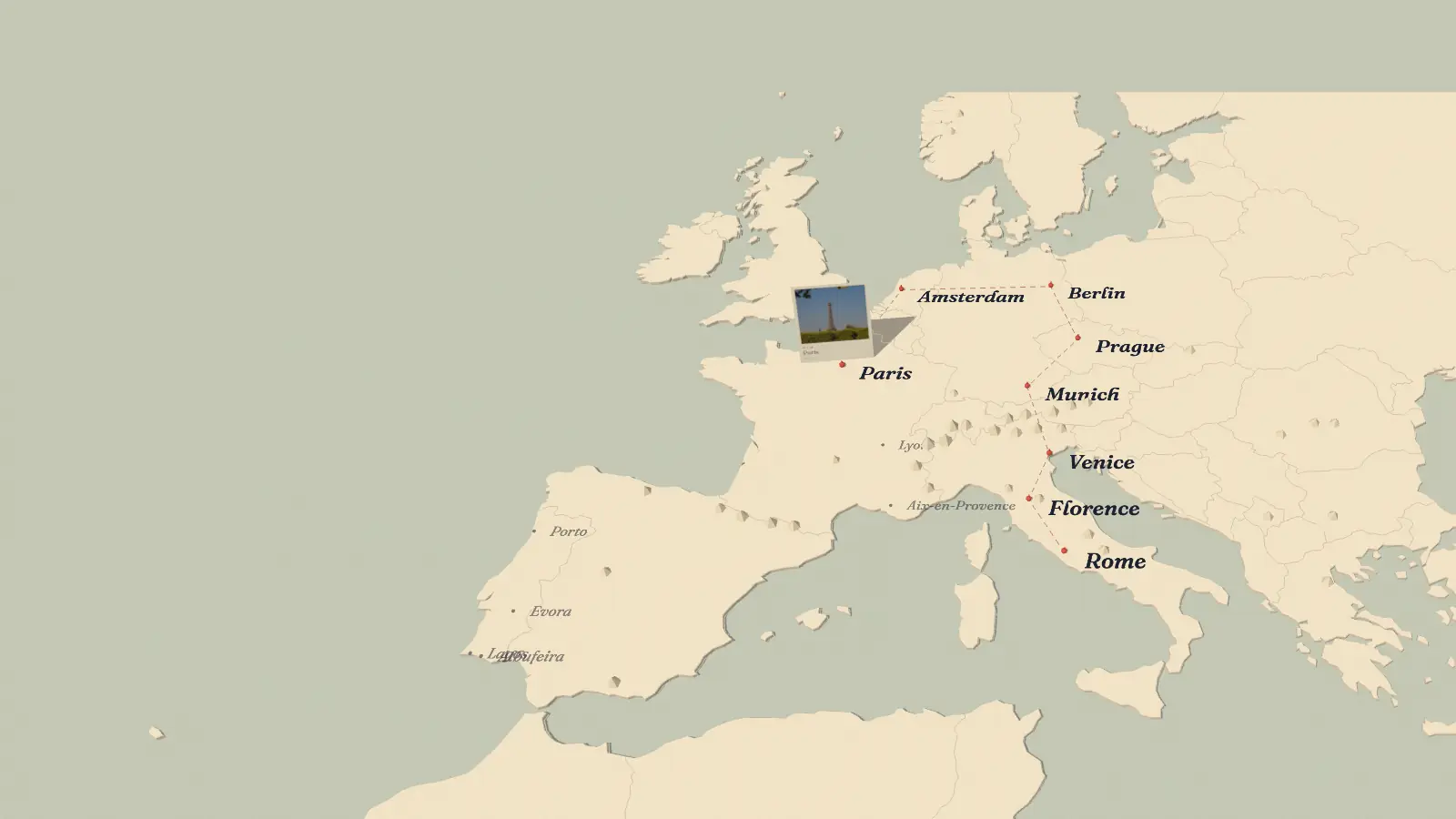 A paper map of Europe with a coral thread running from Paris to Rome and a postcard of Paris standing on the map