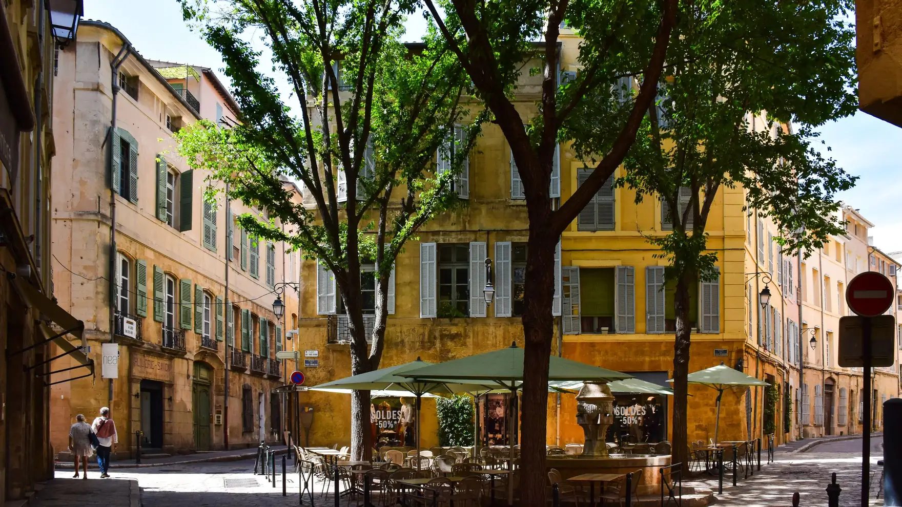 Picturesque street corner in Aix-en-Provence, showcasing traditional architecture and vibrant outdoor café setting