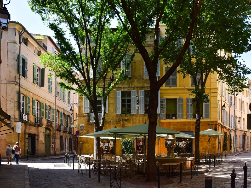 Picturesque street corner in Aix-en-Provence, showcasing traditional architecture and vibrant outdoor café setting