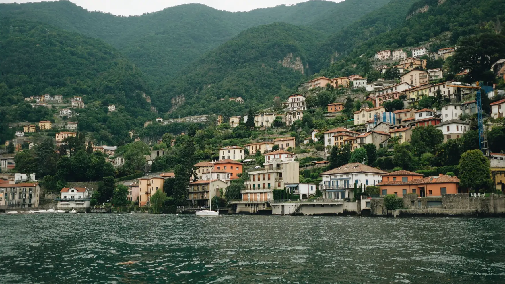 Charming view of hillside villages along Lake Como, surrounded by lush greenery in Lombardy, Italy
