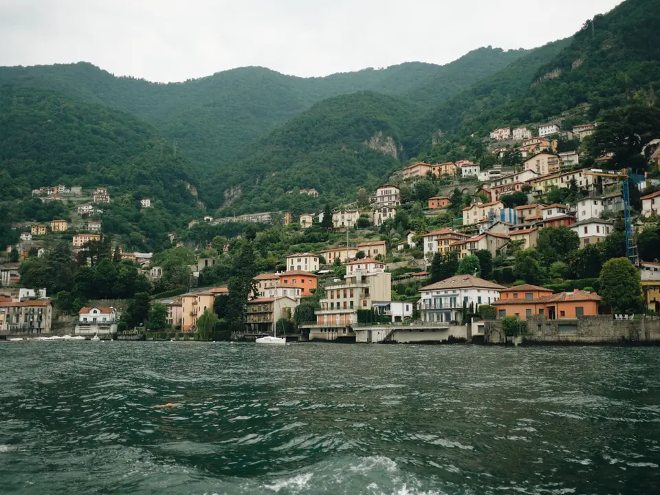 Charming view of hillside villages along Lake Como, surrounded by lush greenery in Lombardy, Italy