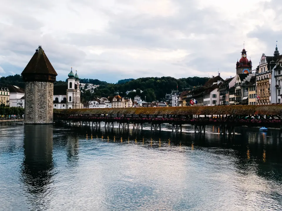 Beautiful view of the Chapel Bridge and Water Tower in Lucerne, reflecting on the Reuss River