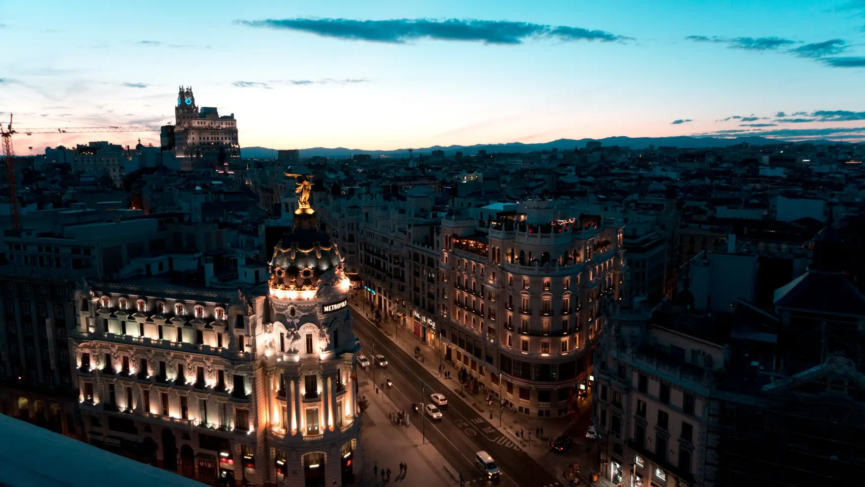 A stunning view of Madrid cityscape during twilight with beautifully illuminated buildings and clear skies