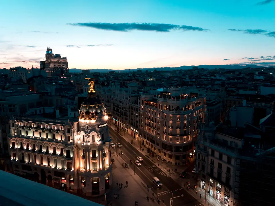 A stunning view of Madrid cityscape during twilight with beautifully illuminated buildings and clear skies