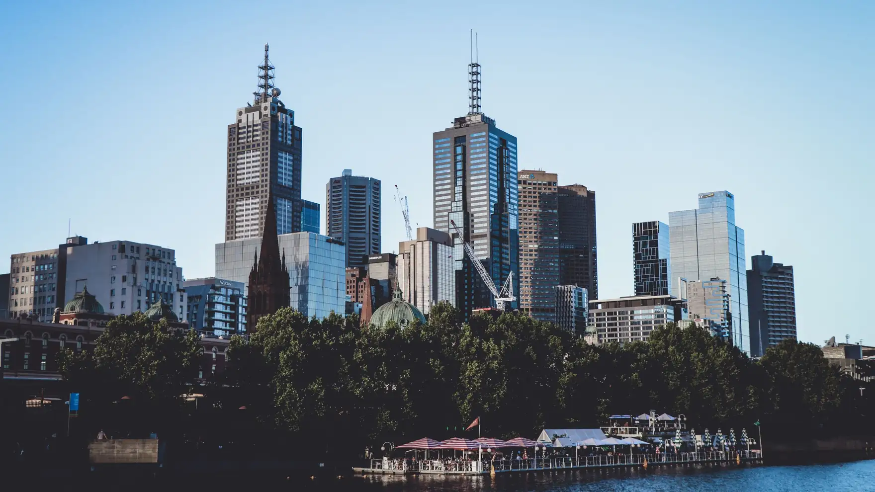 A breathtaking view of Melbourne's skyline over the waterfront, showcasing modern skyscrapers