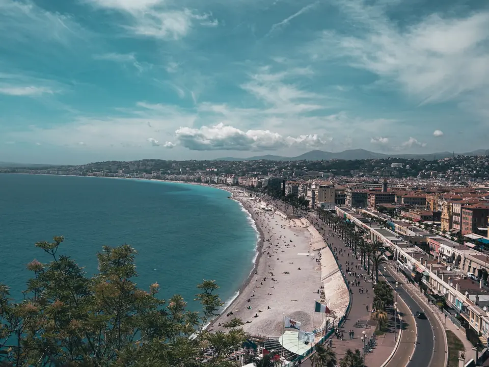 Stunning aerial view of Nice, France with bustling beachfront under a clear summer sky
