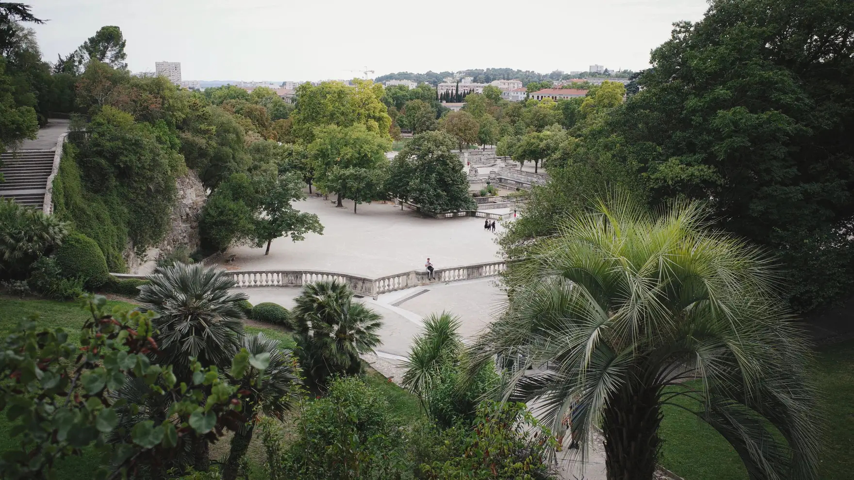 Explore the vibrant greenery and scenic layout of a garden in Nîmes, Occitanie, France