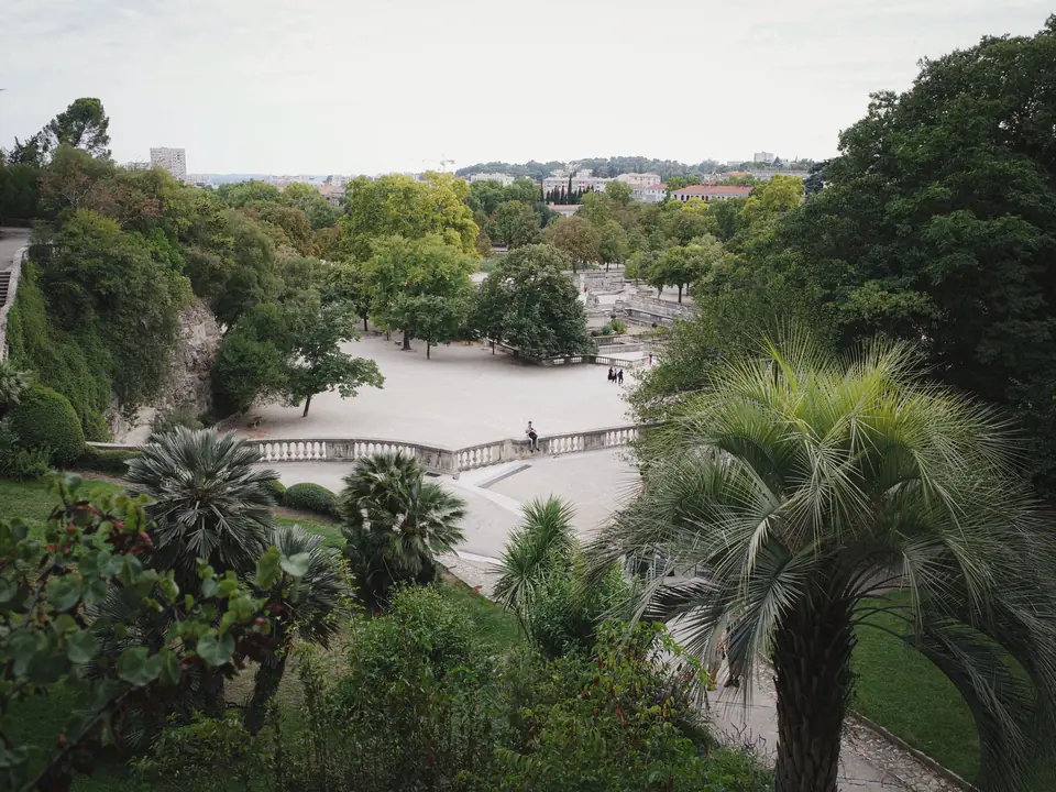 Explore the vibrant greenery and scenic layout of a garden in Nîmes, Occitanie, France