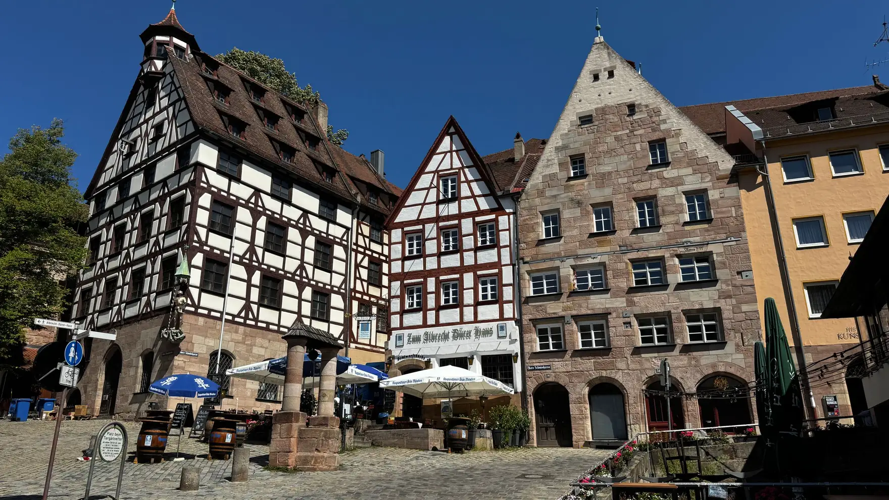 Historic half-timbered buildings in Nuremberg's old town under clear blue skies, capturing medieval charm