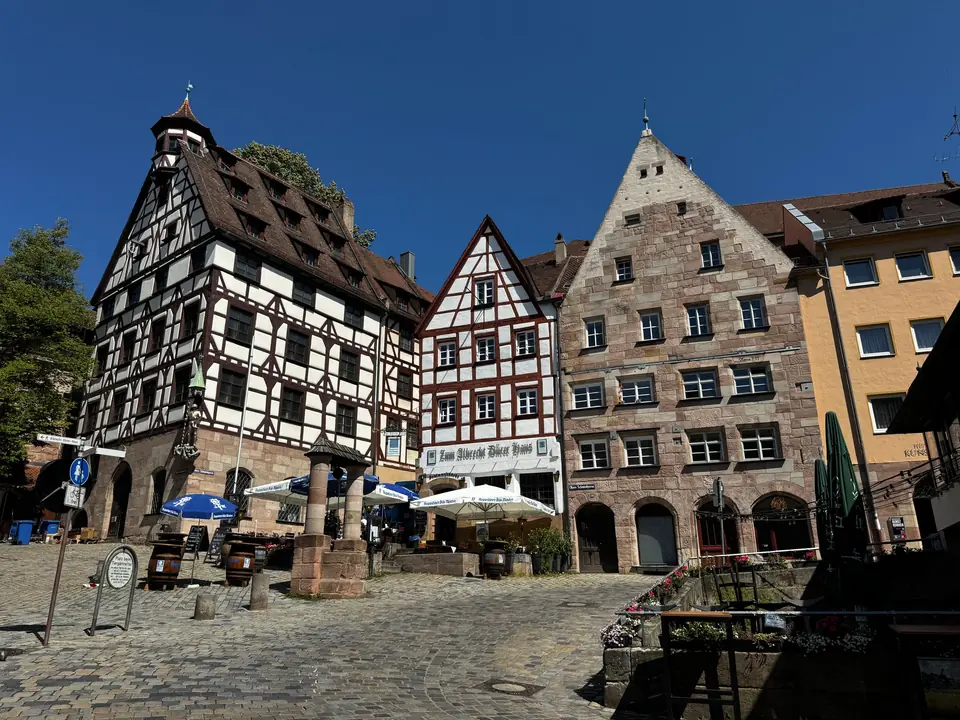 Historic half-timbered buildings in Nuremberg's old town under clear blue skies, capturing medieval charm