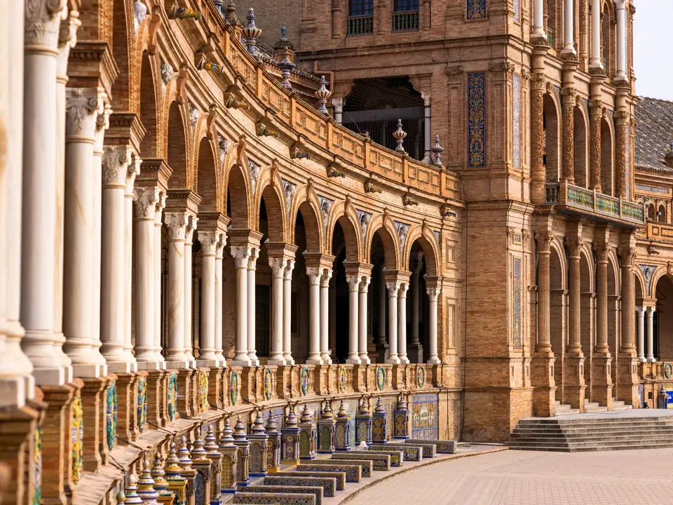 Elegant arches and ornate architecture of Plaza de España in Seville, Spain, showcasing historical grandeur