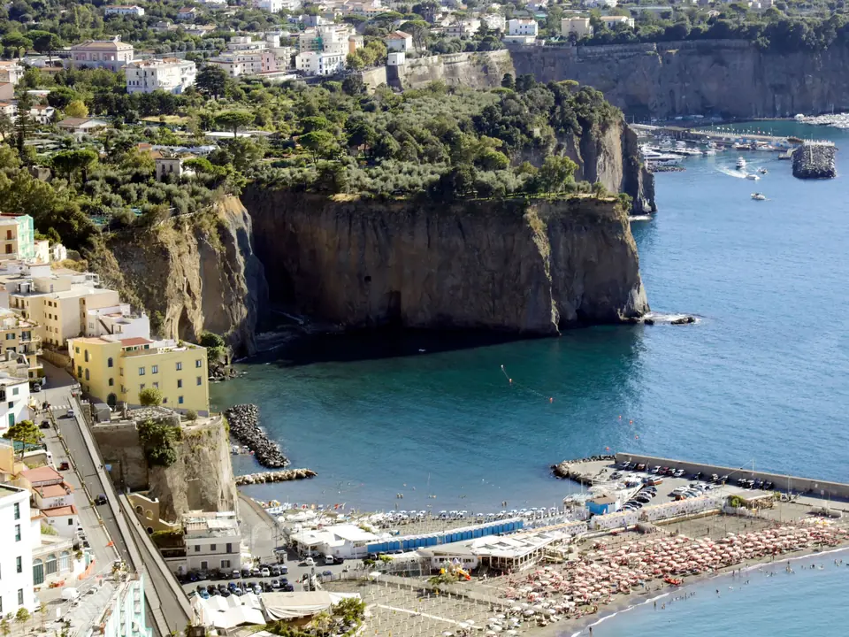 Stunning aerial shot of Sorrento's cliffs and beach in Naples, Italy, with vibrant sea views